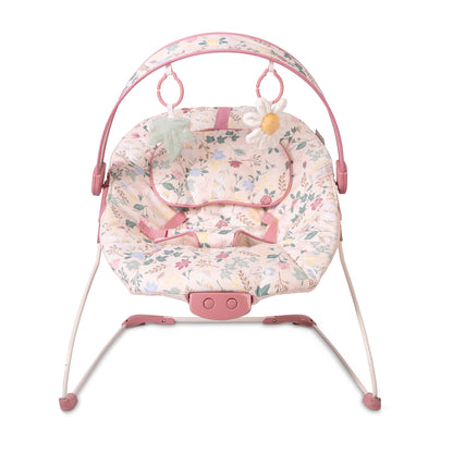 Red Kite Cozy Bounce musical baby bouncer in rose and ivy colors, featuring a soft fabric seat and musical toy arch for infants.