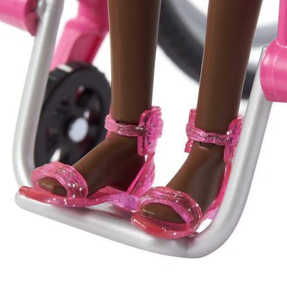 Barbie Fashionistas doll in a rainbow heart romper, with a wheelchair and ramp, featuring curly black hair and accessories.