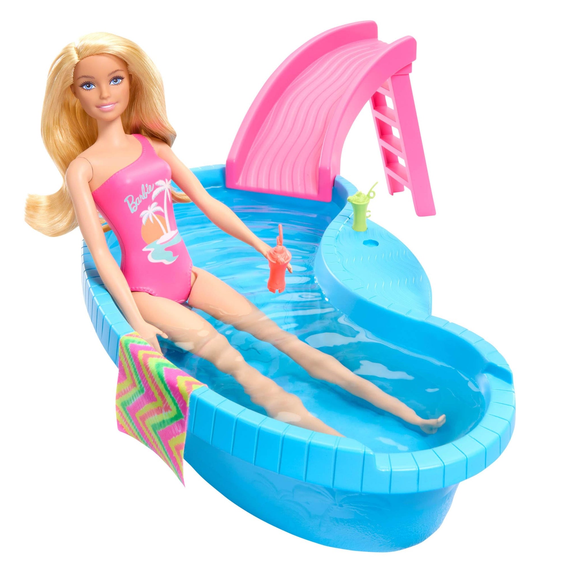 Barbie doll in a tropical pink swimsuit with pool, slide, towel, and drink accessories in a vibrant playset scene.