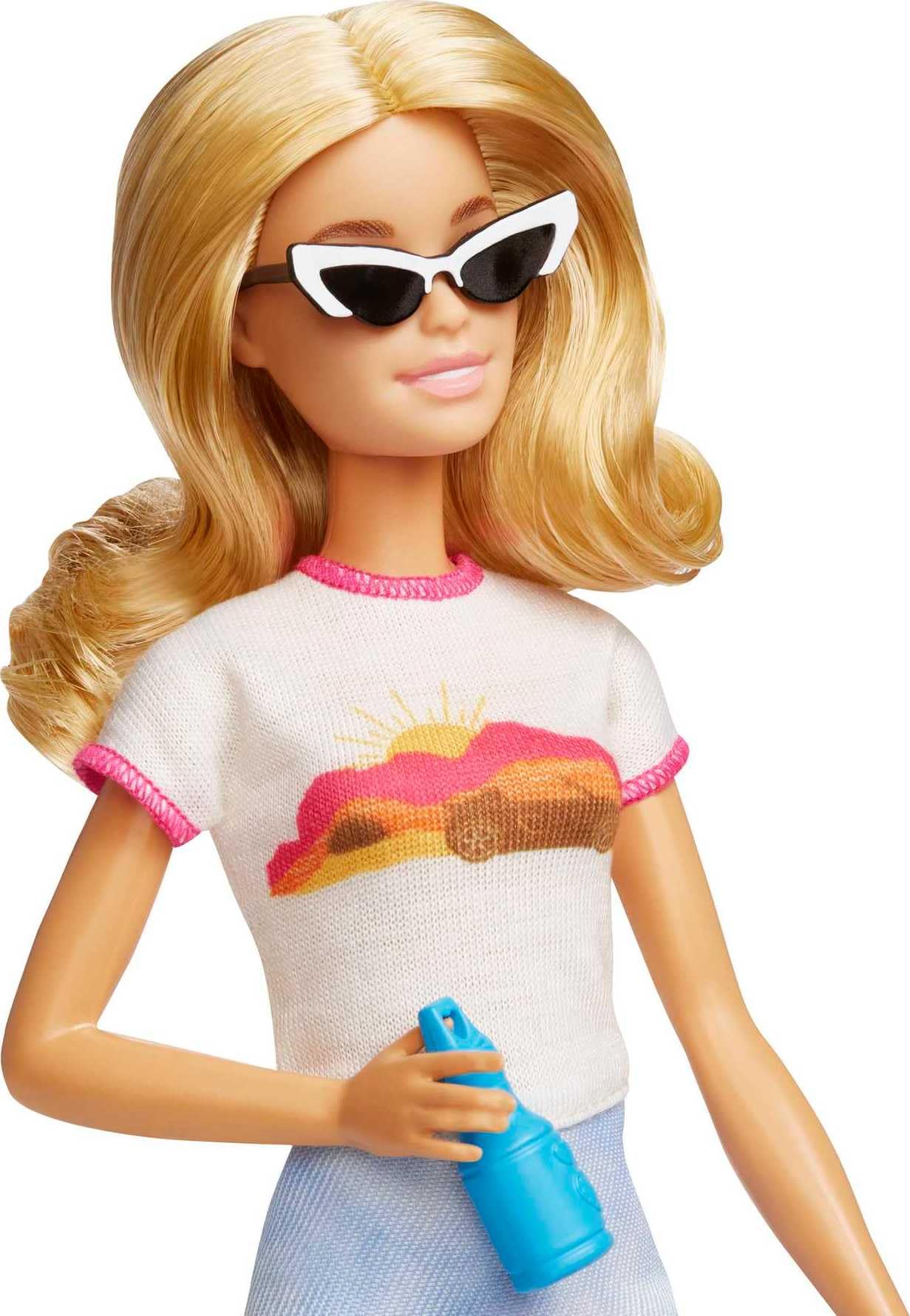Barbie Malibu doll with blonde hair in a travel set, including puppy and suitcase, showcasing 10+ accessories.