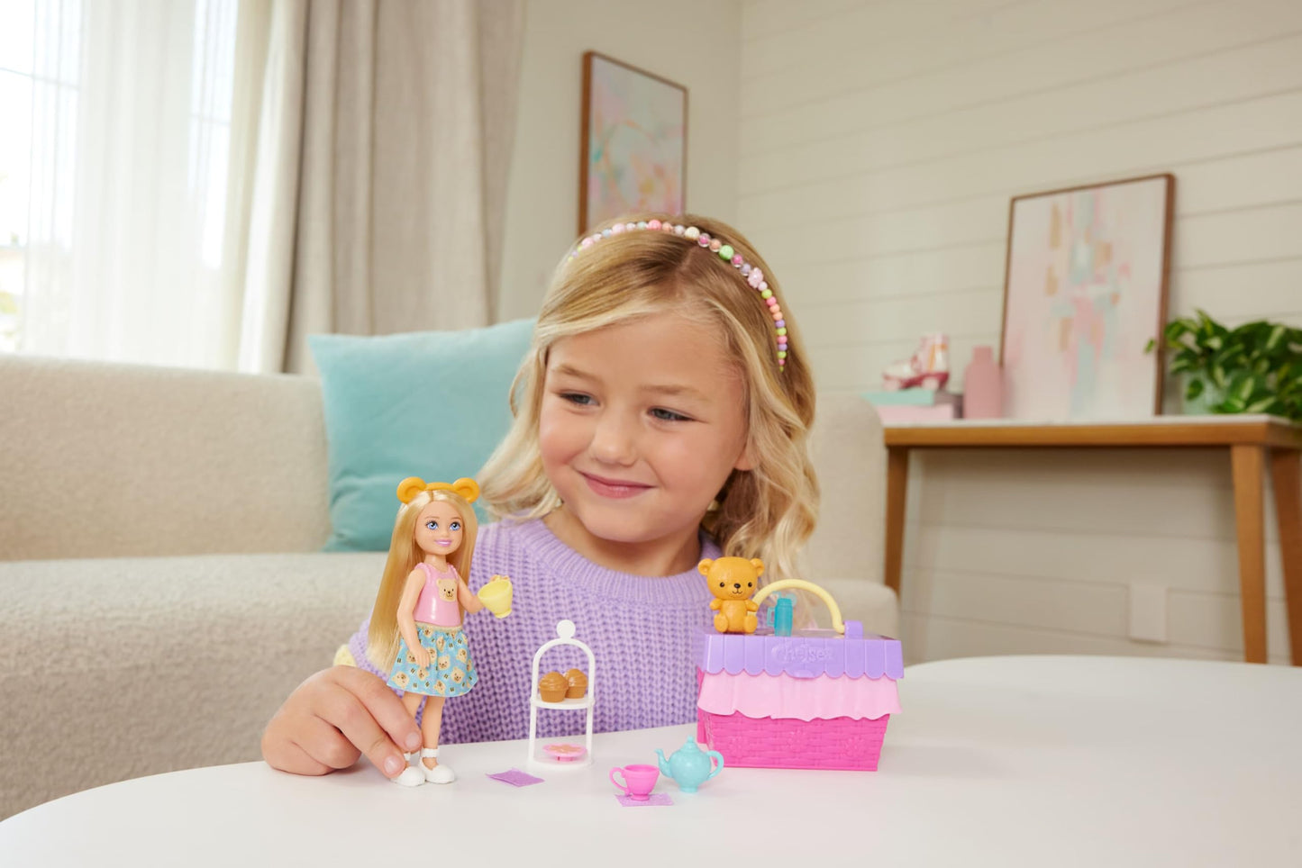 Barbie Chelsea Pop-Up Tea Party Playset featuring blonde doll, picnic basket, and various accessories for imaginative play.