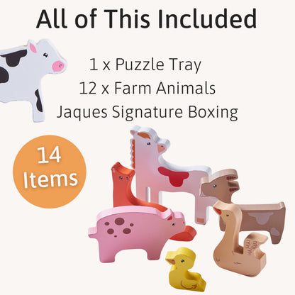 Wooden farm animal toys by Jaques of London for toddlers, including a cow, pig, and sheep on a wooden farm puzzle.