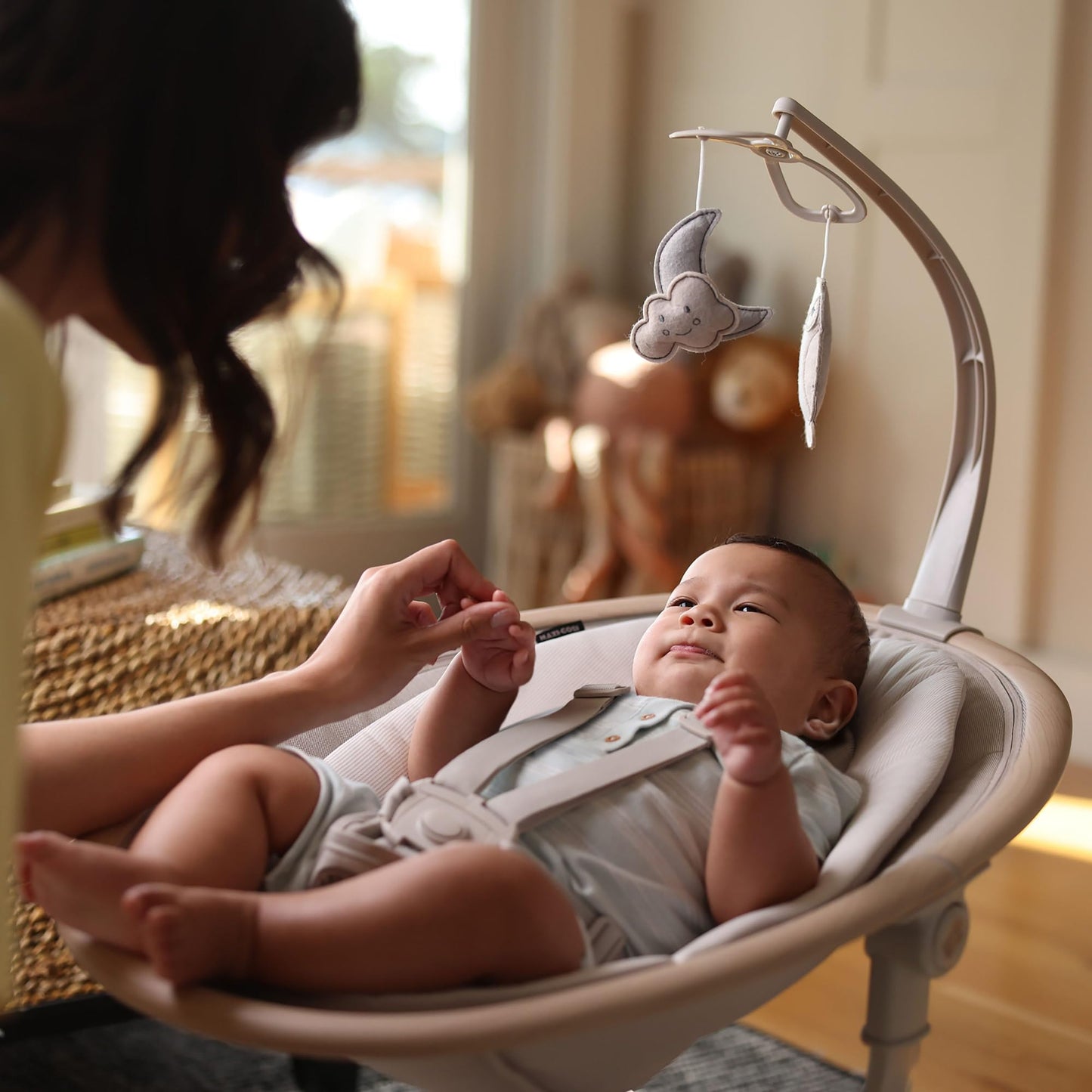Maxi-Cosi Cassia electric baby swing chair in classic beige with 360° seat rotation, 12 melodies, and adjustable recline for infants.