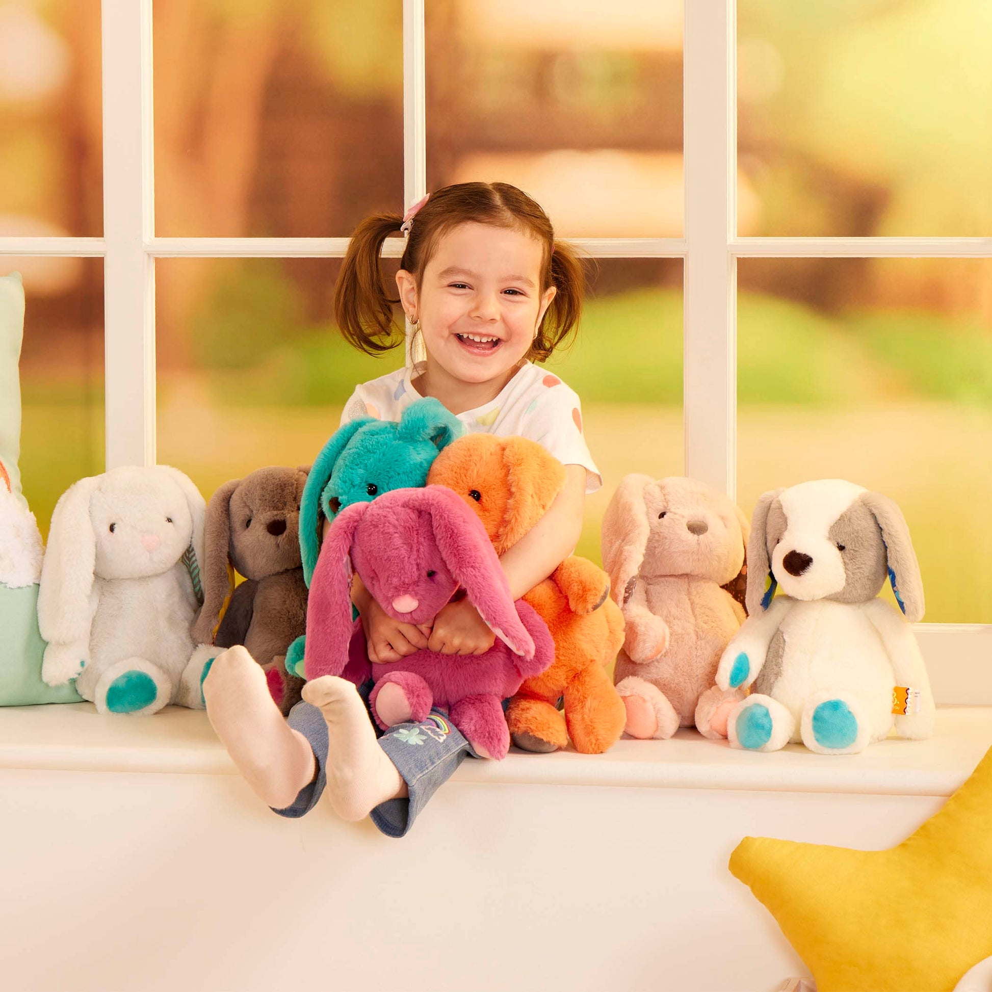 Soft B. toys Plush Elephant Doll, cuddly stuffed animal for all ages, machine washable, featuring a gentle gray elephant with big ears.