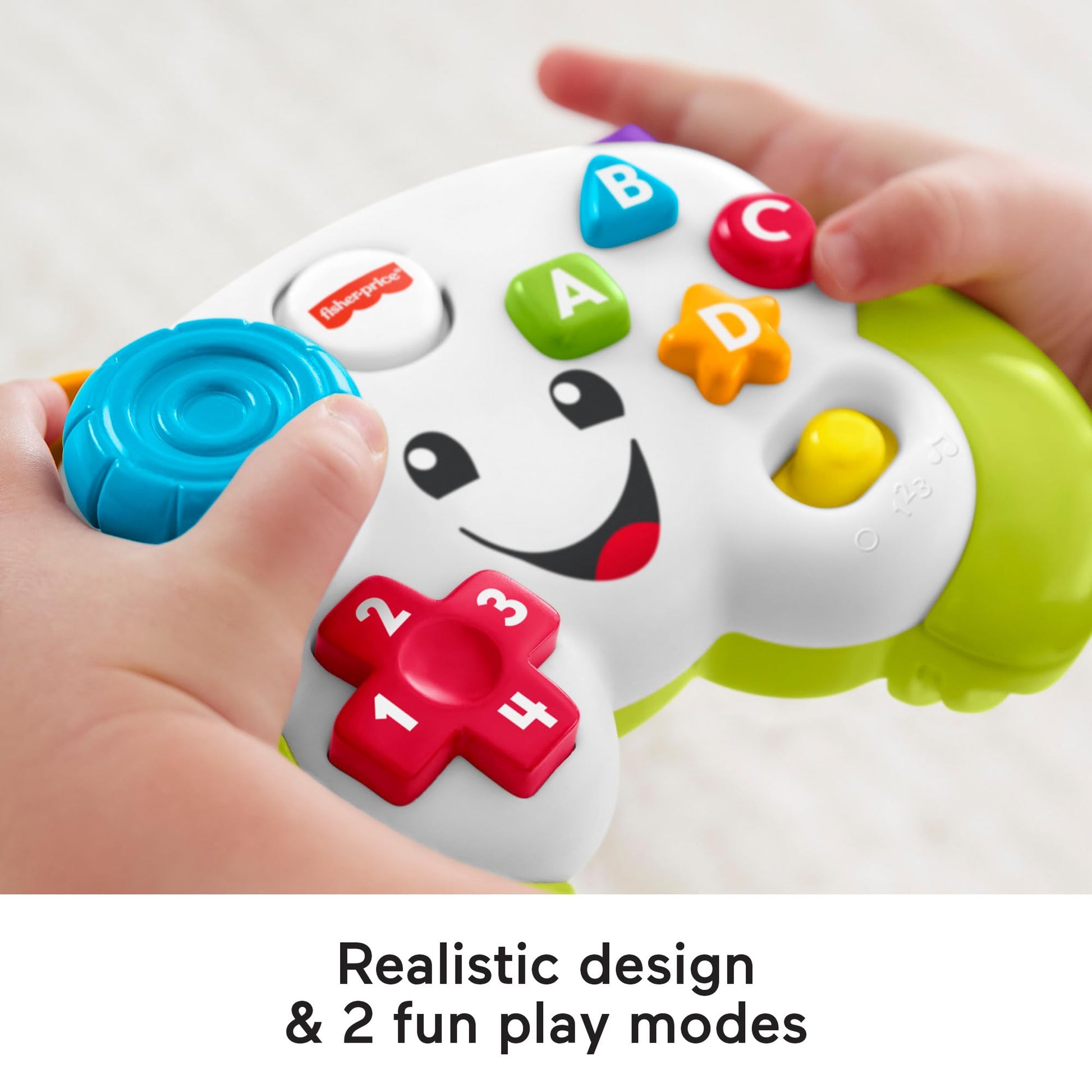 Fisher-Price Laugh & Learn game controller toy in green for infants 6+ months, with musical and learning features.