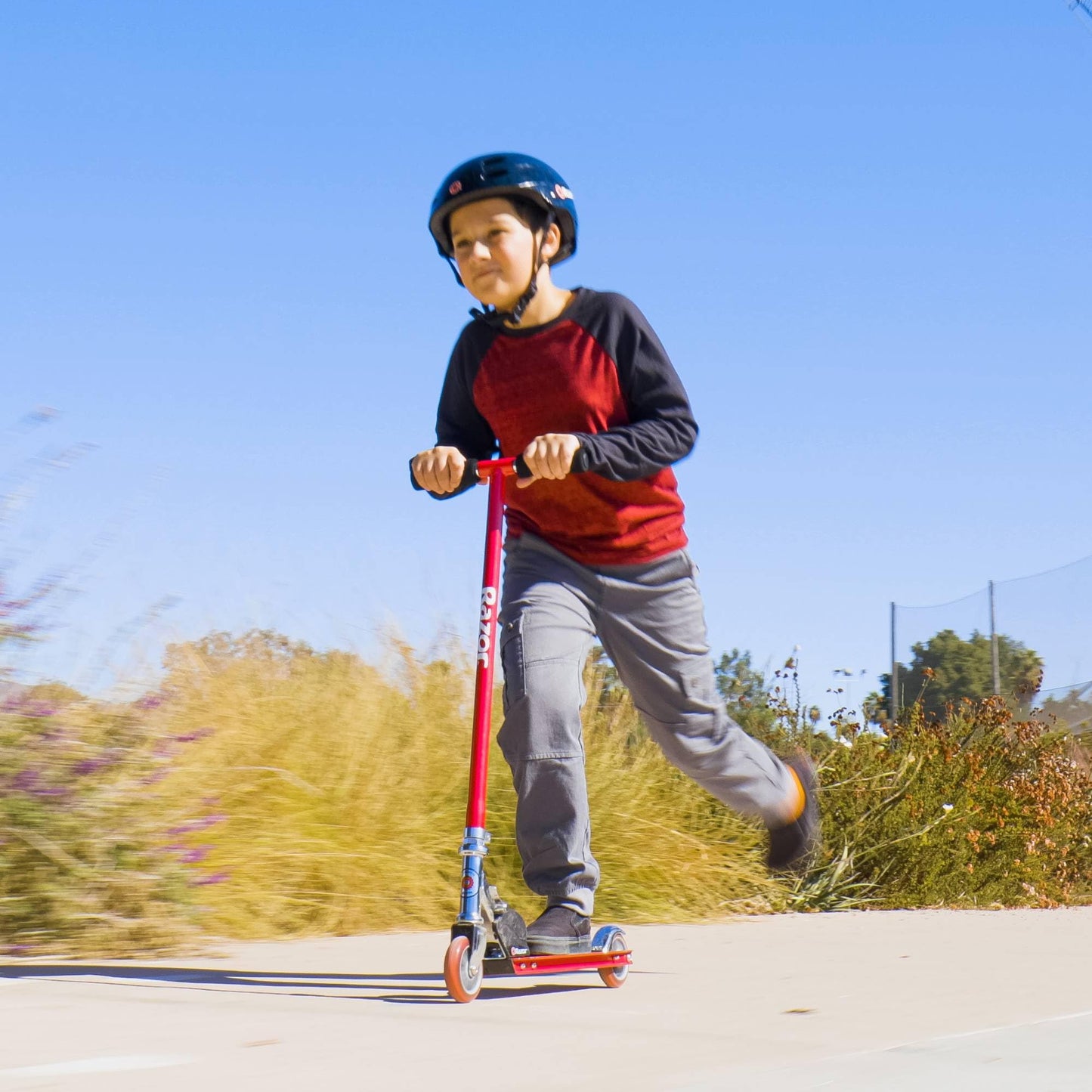 Razor S Real Steel Kick Scooter in vibrant red, showcasing its sturdy frame and smooth wheels on a flat surface.