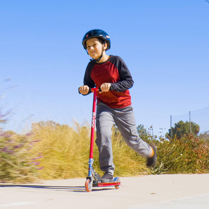 Razor S Real Steel Kick Scooter in vibrant red, showcasing its sturdy frame and smooth wheels on a flat surface.