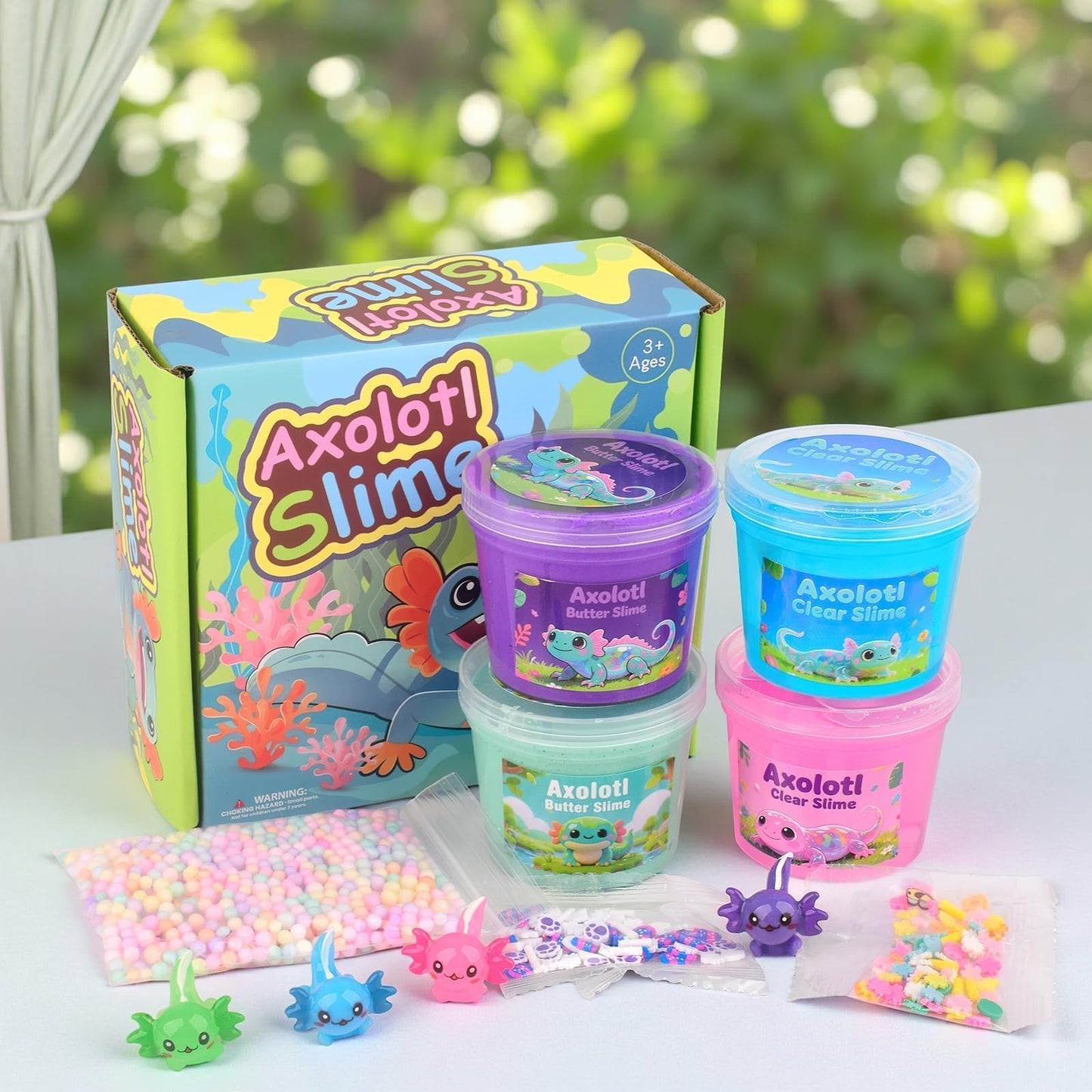 Four-pack axolotl fluffy slime kit with pink, blue, purple, and green slime, includes charms, soft and stretchy for kids and classroom fun