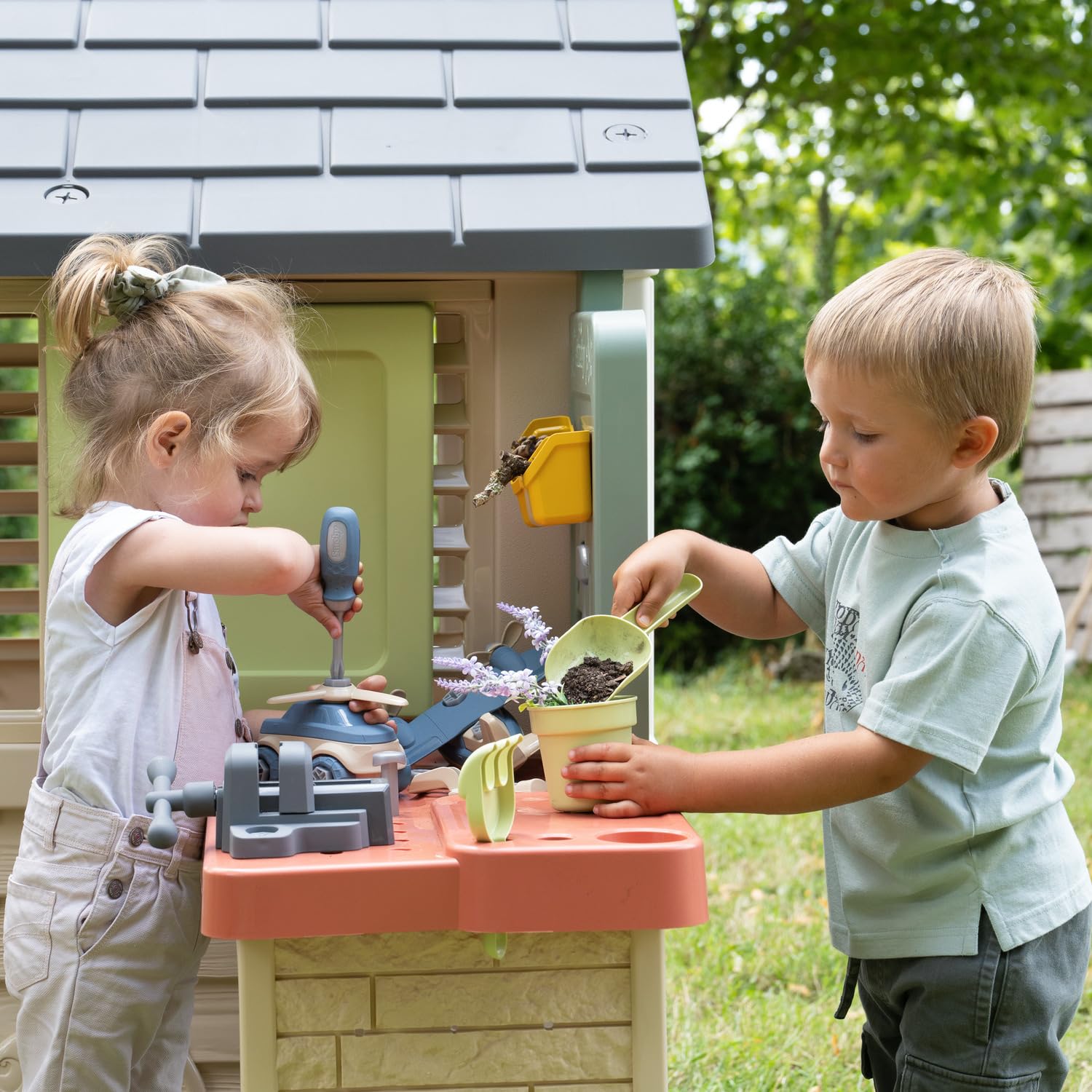 Smoby Life Nature Playhouse with Workshop featuring colorful plastic construction, windows, door, and outdoor play area.