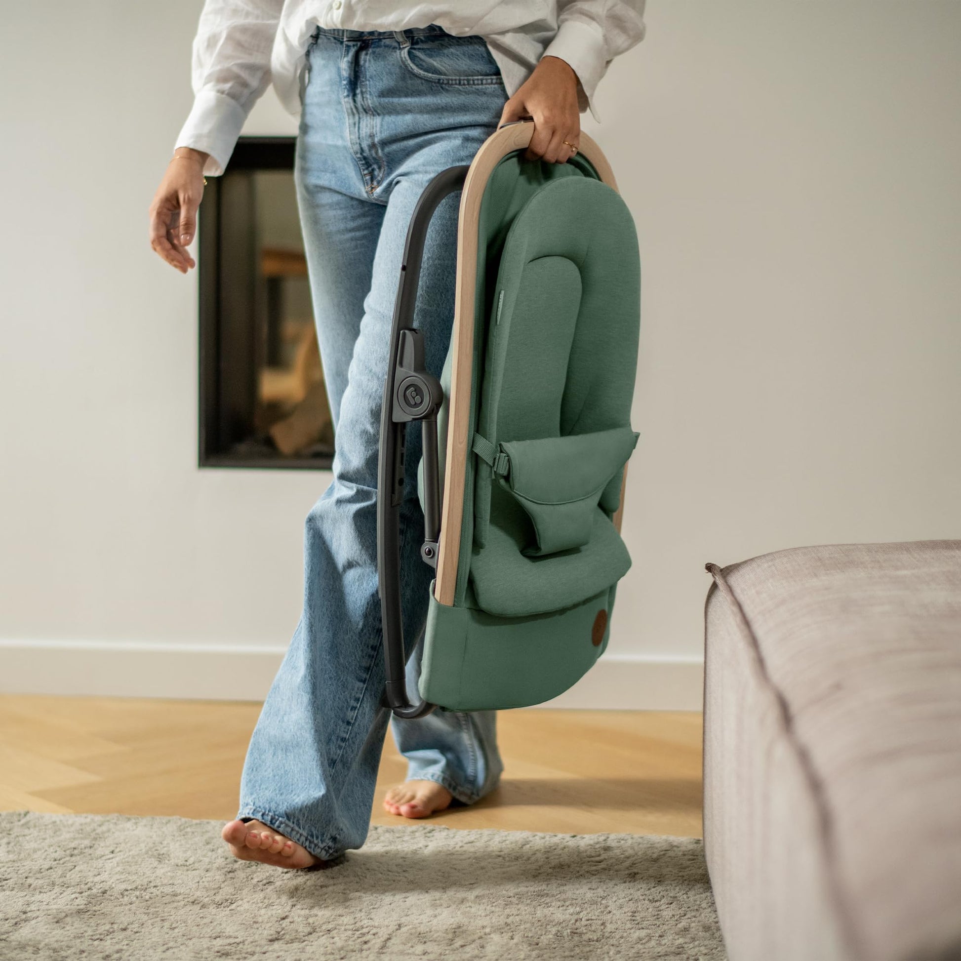 Maxi-Cosi Kori 2-in-1 baby bouncer chair with toy arch, adjustable recline, lightweight design, and newborn pillow in Beyond Graphite color.
