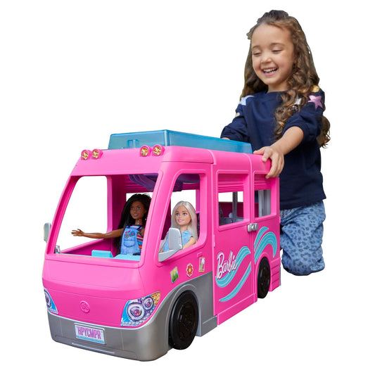Barbie Dream Camper in pink with play areas, two puppies, pool, and slide, designed for imaginative play for ages 3 and up.