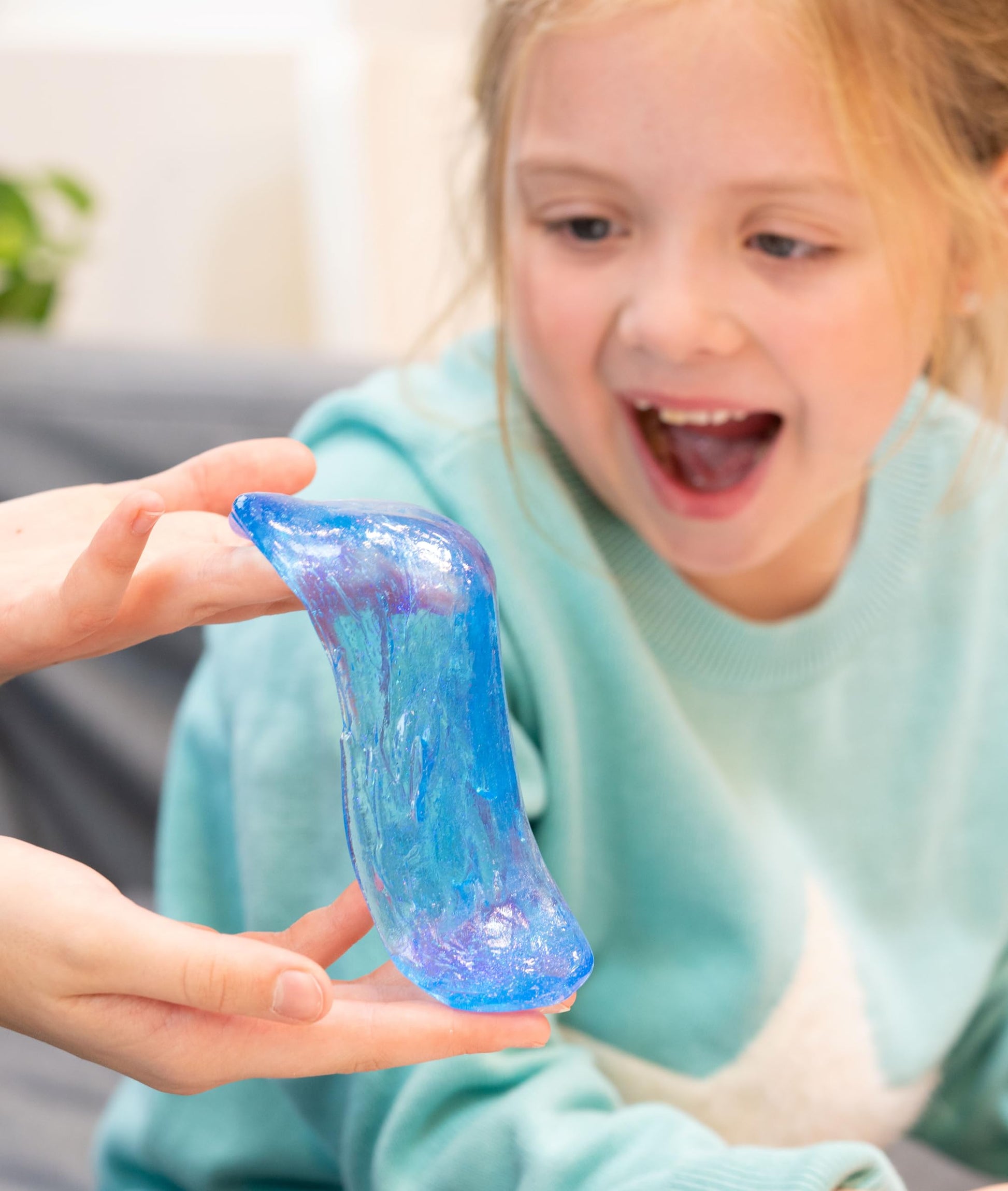 Crazy Aaron's Liquid Glass Thinking Putty in Falling Water, crystal clear blue, showcasing its smooth, moldable, and shiny silicone-like texture.