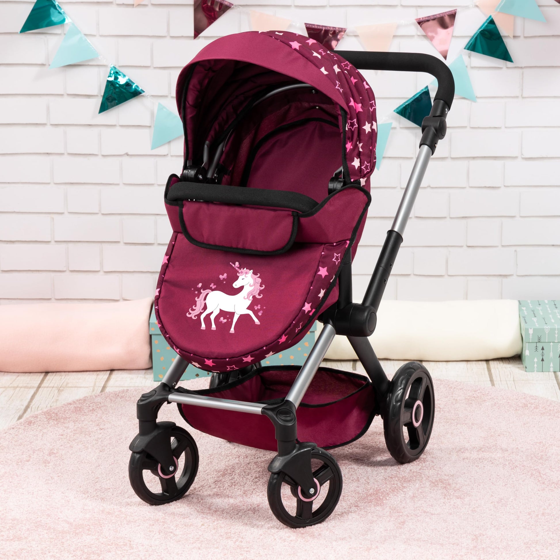 Bayer Baby Dolls Pram XEO in burgundy with pink stars, convertible doll pushchair with adjustable handle, carrycot, and changing bag.