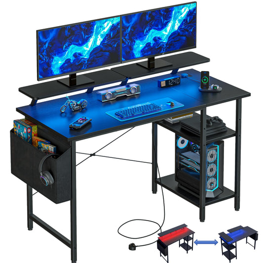Black DOMSHOCT gaming desk with LED lights, power outlets, storage shelves, compact corner design for home office or study use.