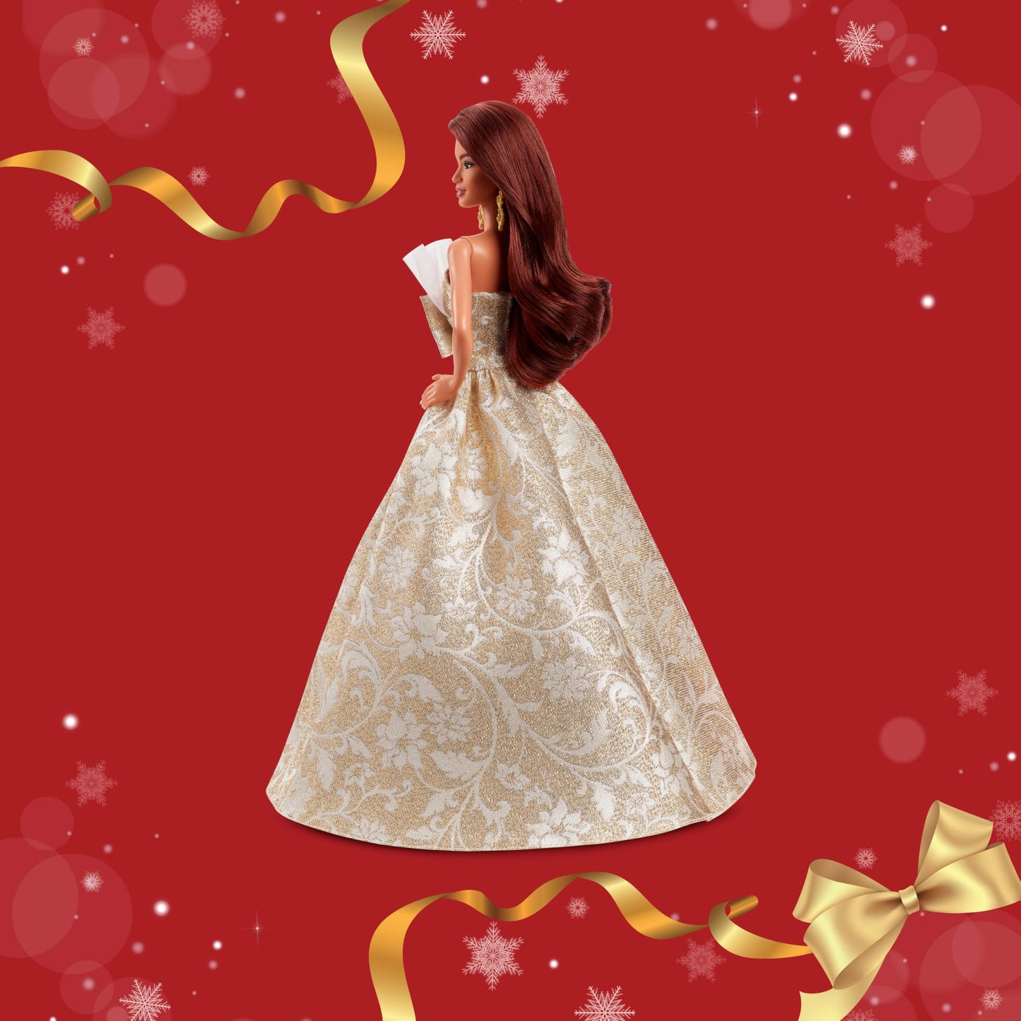 Barbie Signature 2025 Holiday fashion doll with dark brown hair in a silver and gold gown, in display packaging.