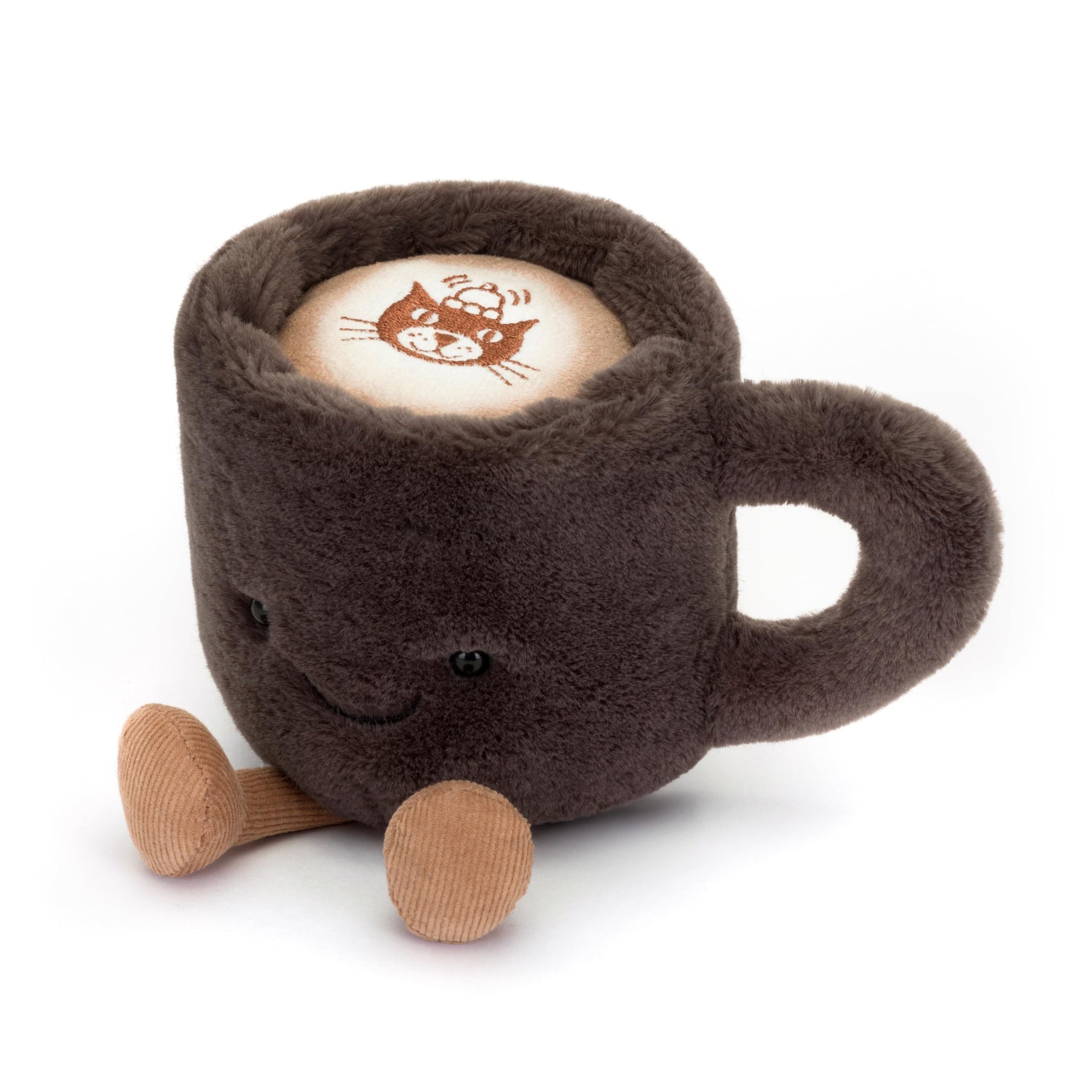 Amuseable Coffee Cup plush toy by Jellycat with a smiling face and soft, textured fabric in a cozy setting.