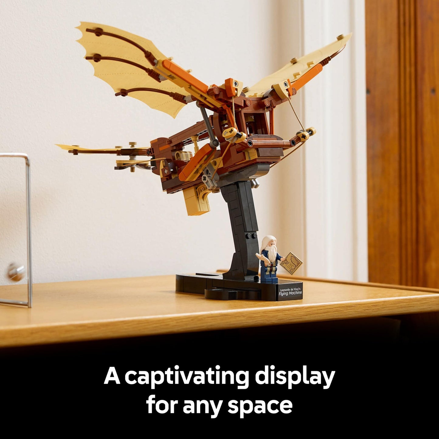 LEGO Icons Leonardo da Vinci’s Flying Machine model kit displayed on a wooden surface, showcasing intricate design details.