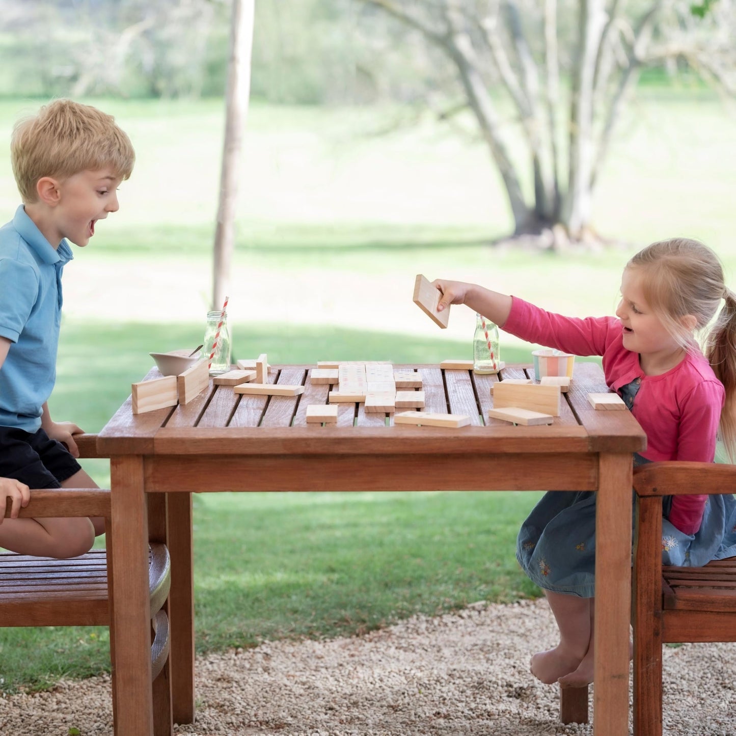 Wooden giant dominoes set by Jaques of London for kids, outdoor garden game with large numbered tiles for children.