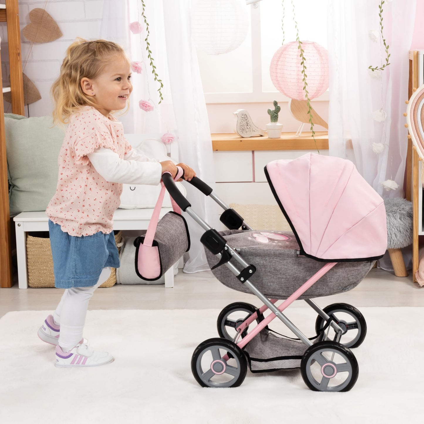 Bayer Cosy Baby Doll Pram with large wheels, foldable design, storage basket, and matching accessories for 46cm dolls.