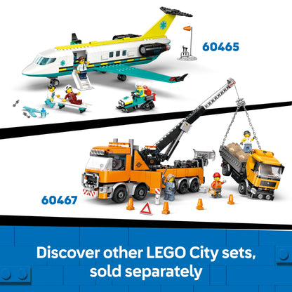 LEGO City yellow bulldozer building set with three minifigures, loose bricks, and road signs for construction play.