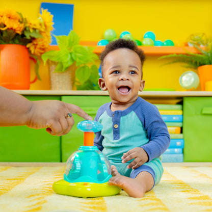 Bright Starts press and glow spinner musical baby toy with multicoloured lights, designed for infants 6 months and older.