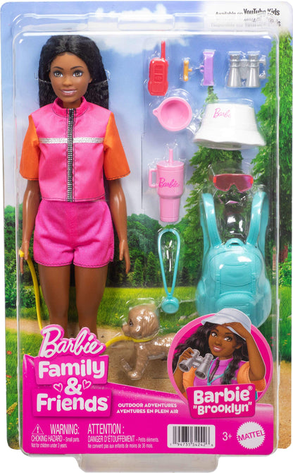 Barbie Brooklyn doll in adventure outfit with camping gear and pet puppy, surrounded by outdoor accessories.