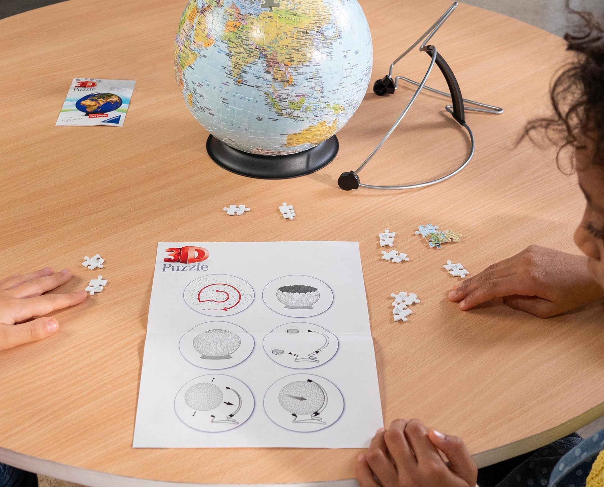 Ravensburger 3D World Globe puzzle on V-stand with 540 plastic pieces, showing assembled globe with detailed world map.