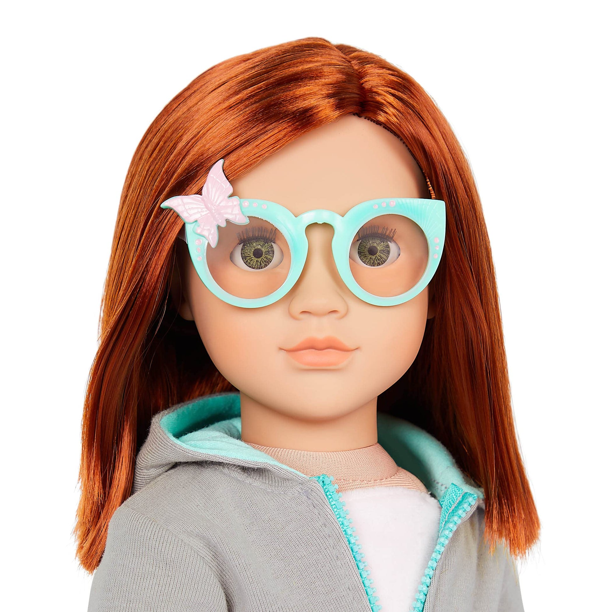 Our Generation Cambi doll with red hair, blue eyes, butterfly-themed outfits, and styling accessories in a gift box.