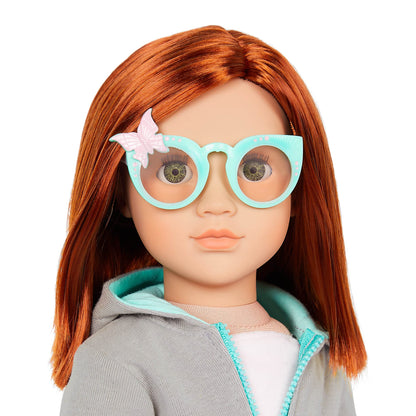 Our Generation Cambi doll with red hair, blue eyes, butterfly-themed outfits, and styling accessories in a gift box.
