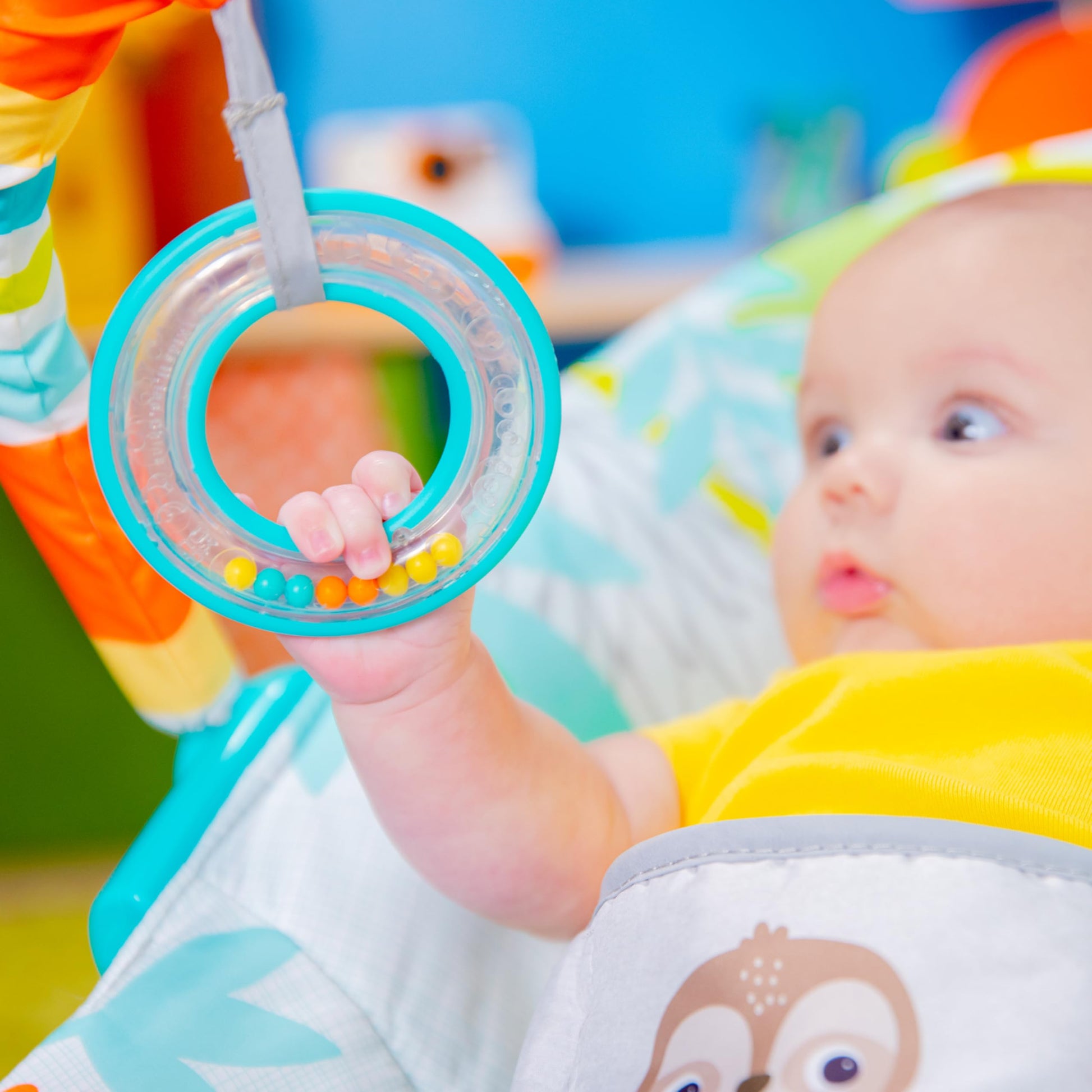 Bright Starts rainforest-themed baby bouncer with soothing vibrations, removable toy bar, and nonslip feet for infants up to 6 months.