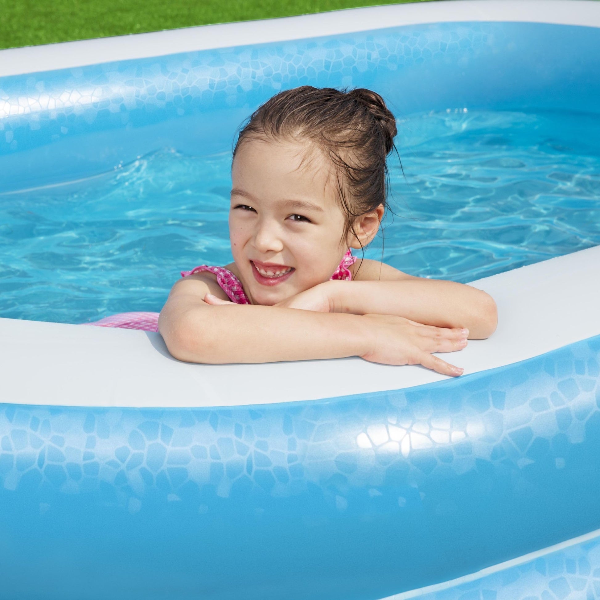 Bestway inflatable family paddling pool in outdoor garden setting, showcasing spacious design for family fun and relaxation.
