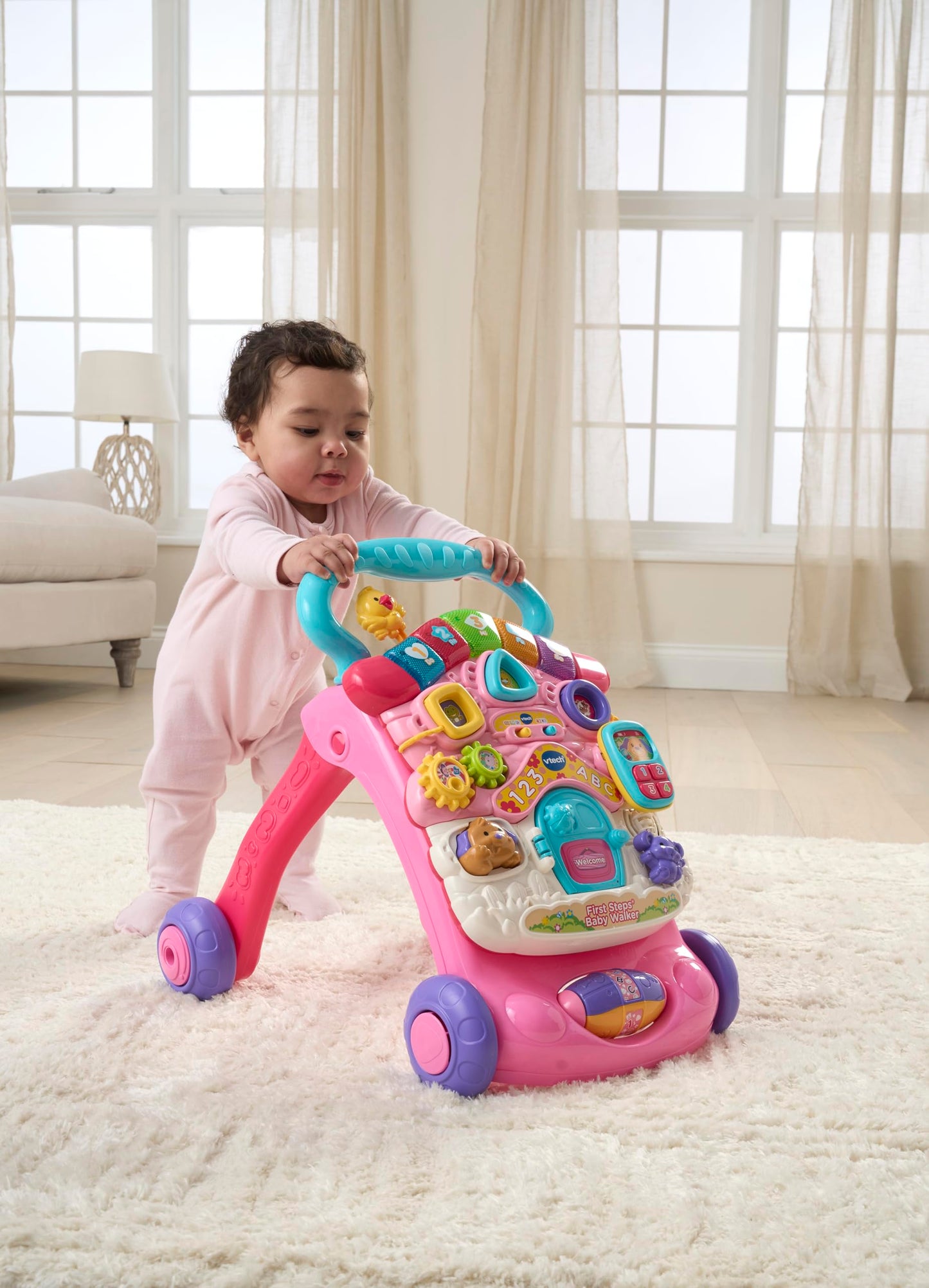 VTech First Steps Baby Walker in pink with shape sorters, sounds, music, phrases, and pretend play features for infants and toddlers.