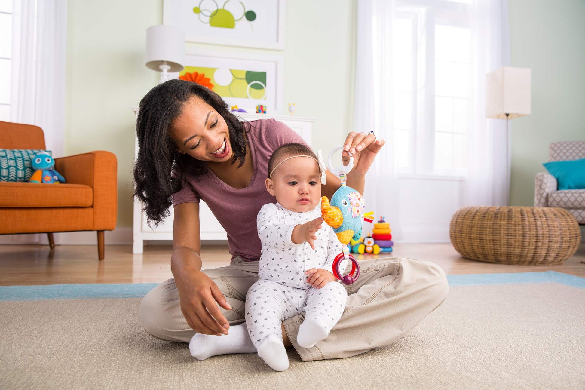LAMAZE Mini Eloy the Elephant baby toy clipped to a pram, sensory plush toy for newborns 0-6 months, colorful and soft.