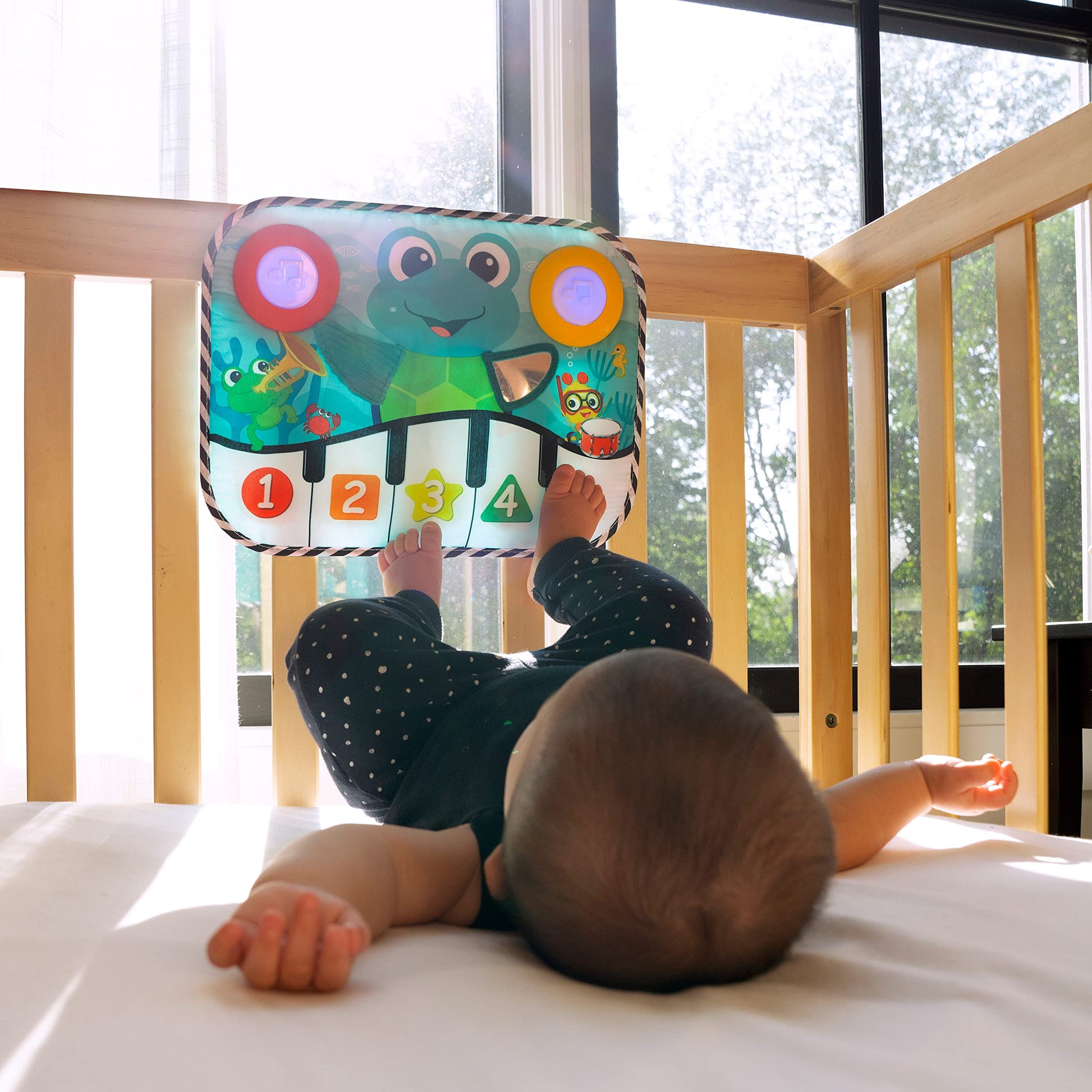 Baby Einstein Ocean Explorers Neptune's Kick & Explore musical crib toy with colorful ocean-themed characters and interactive buttons for babies.