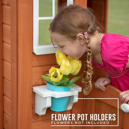 Backyard Discovery Timberlake cedar wood playhouse with toy kitchen, phone, and flowerpot holders, designed for kids aged 2-7.