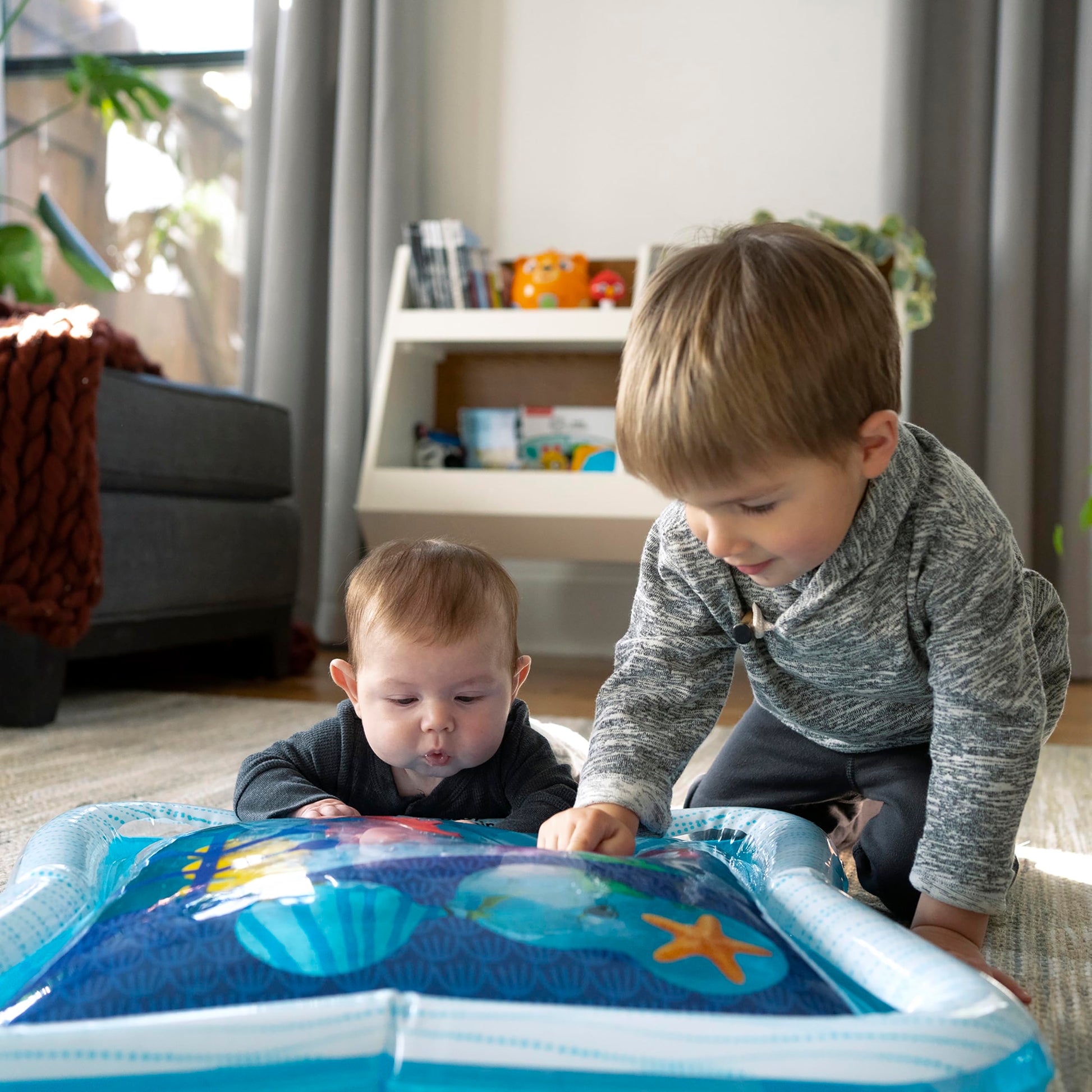 Baby Einstein Opus’ Ocean of Discovery tummy time water play mat with sensory toys for newborns and babies.