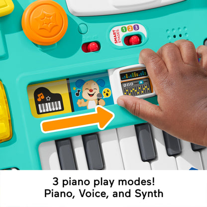 Fisher-Price Laugh & Learn Mix & Learn DJ Table for babies and toddlers, showing colorful musical buttons and lights.