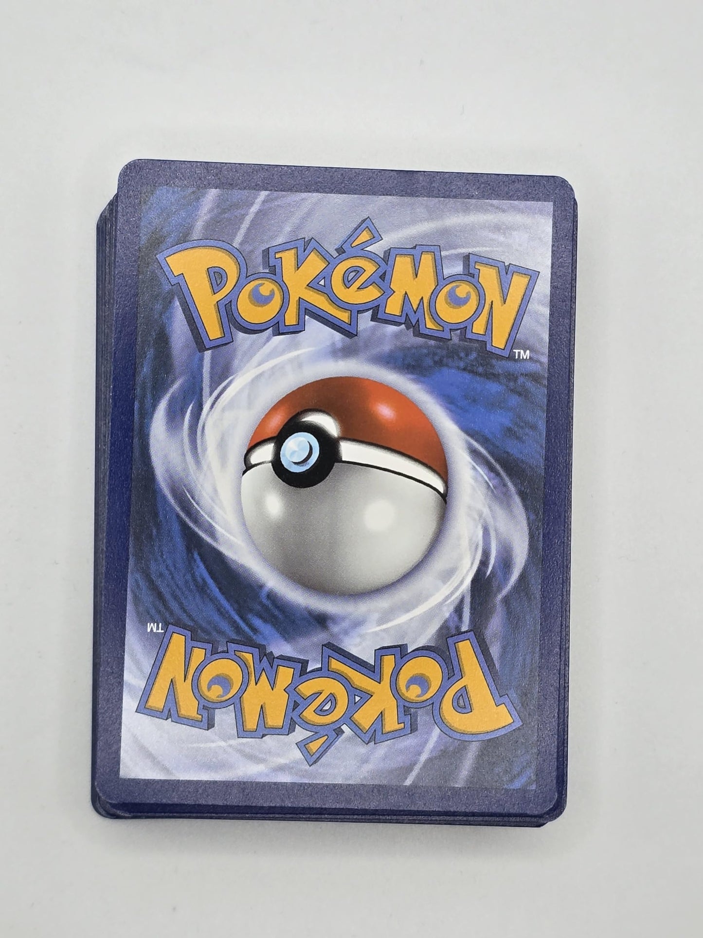 Assorted Pokémon cards in a collection of 50 pieces featuring various characters and designs.