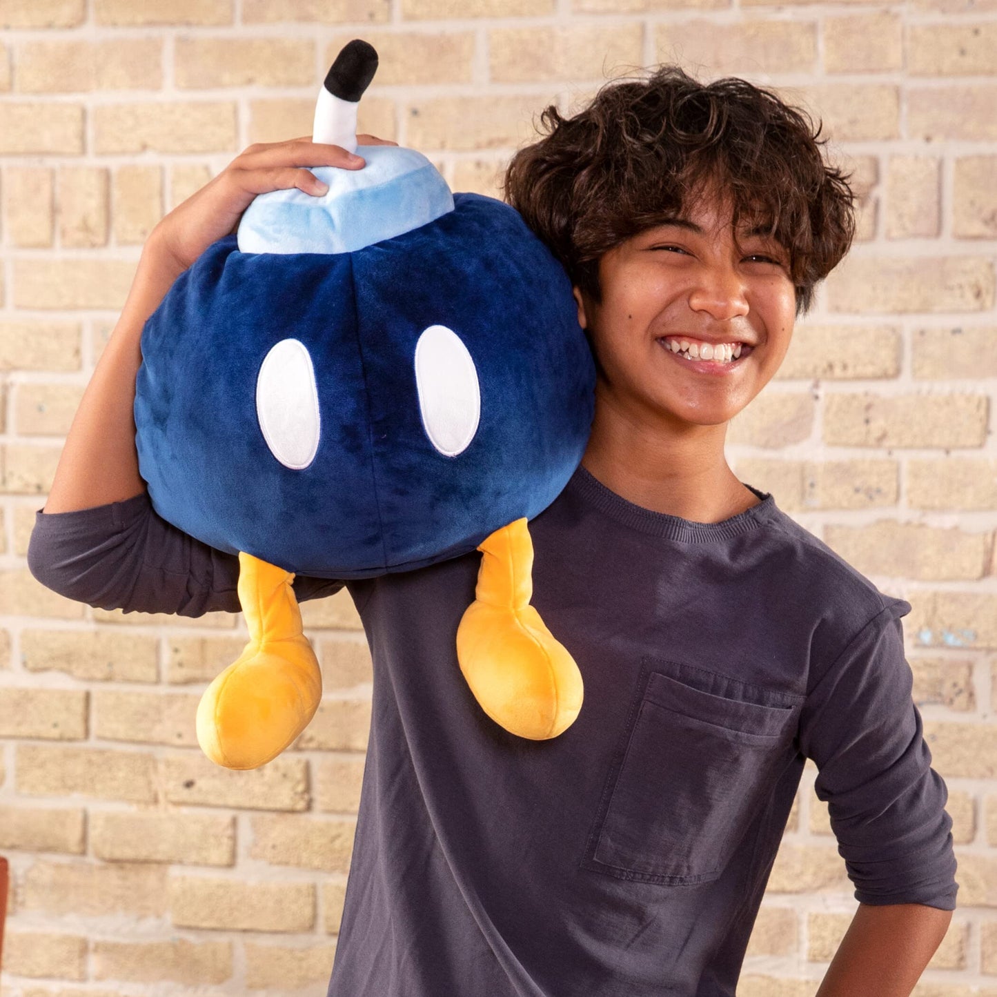 Blue TOMY Mega Bob-Omb plush toy from Club Mocchi Mocchi, Nintendo licensed plush with detailed stitching and soft fabric.