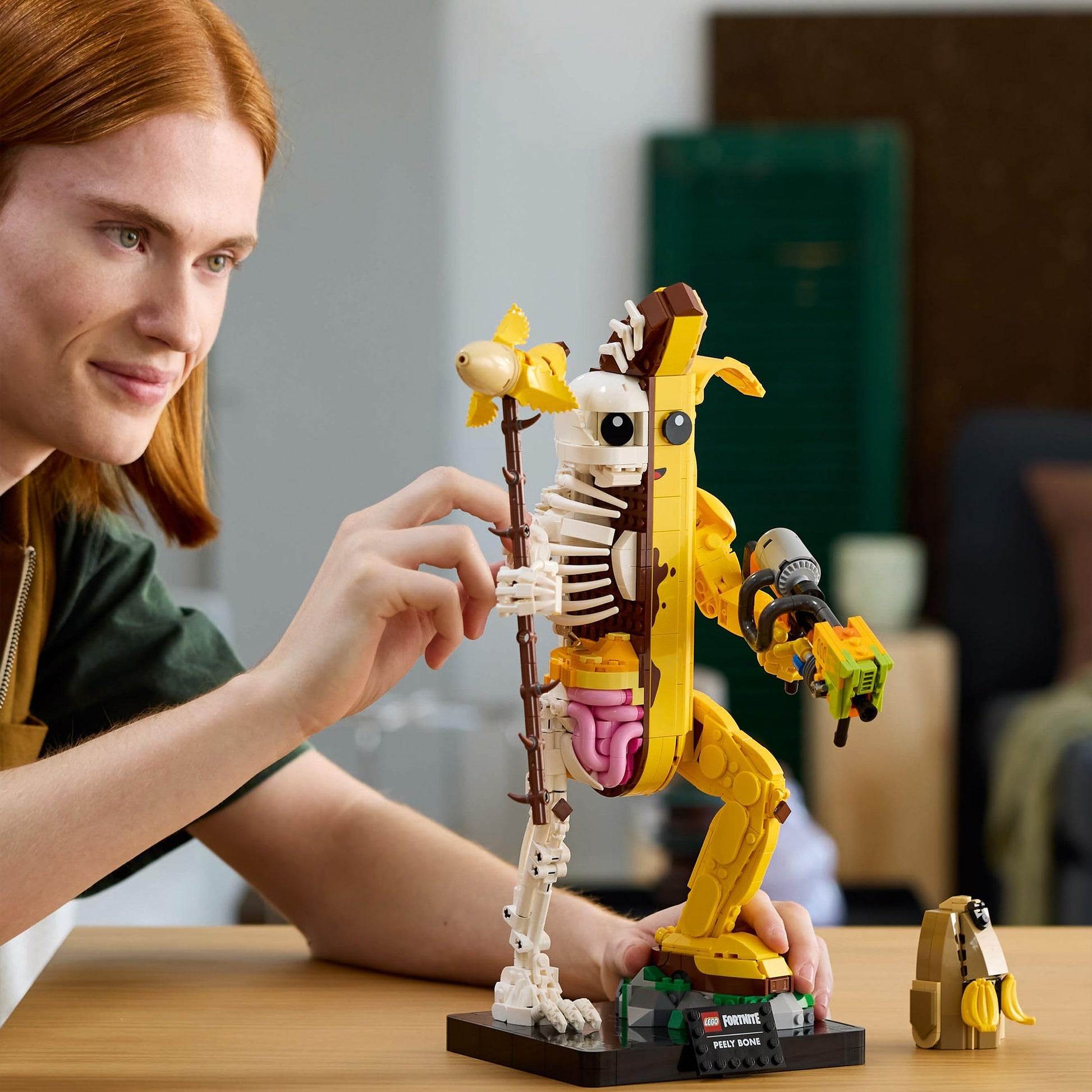 LEGO Fortnite Peely Bone collectible figure with paint launcher and Peely pickaxe, designed for DIY building and display.