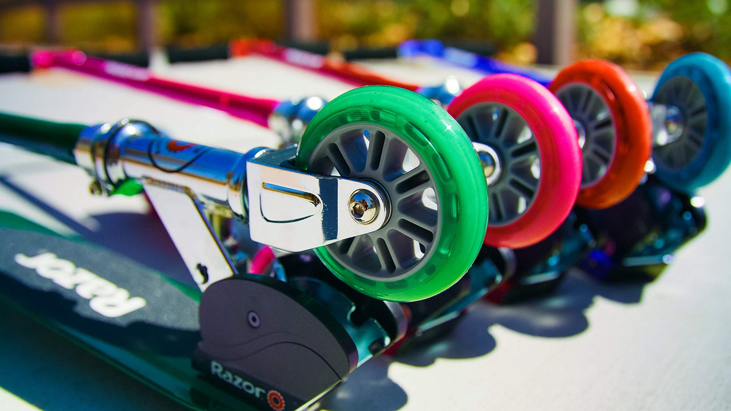 Pink Razor S Real Steel Kick Scooter leaning against a wall, showcasing its durable frame and stylish design.