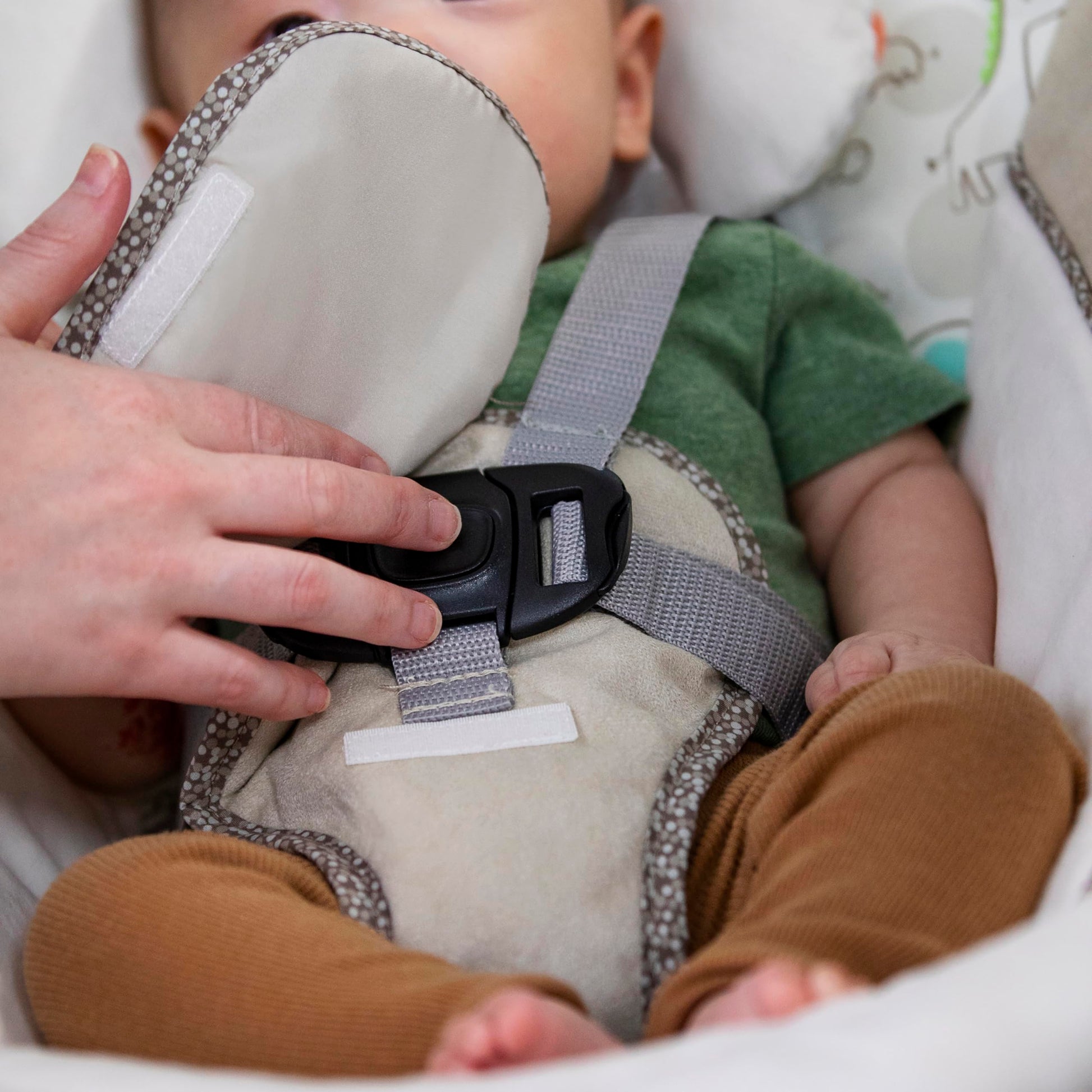 Ingenuity Soothe 'n Delight compact baby swing with music, toy bar, and foldable design for easy travel, beige fabric and frame.