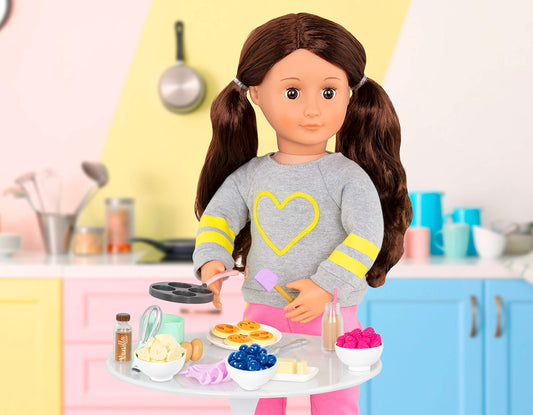 Our Generation pancake breakfast kit with realistic toy food accessories for 18-inch dolls, featuring 23 pieces.