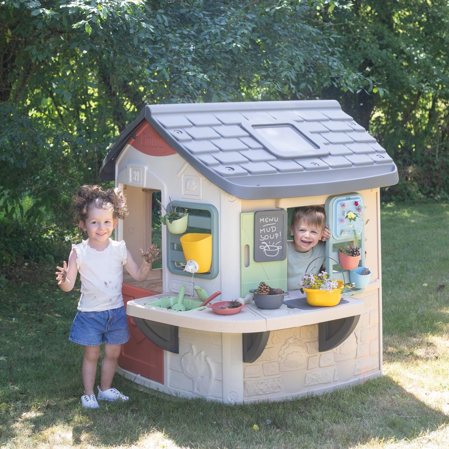 Smoby Life Mud Cooking House toy with colorful play kitchen, utensils, and mud area for imaginative outdoor fun.