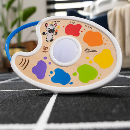Baby Einstein Playful Painter Magic Touch Color Palette light-up toy for babies 6+ months, featuring multicolor design and interactive paint palette.