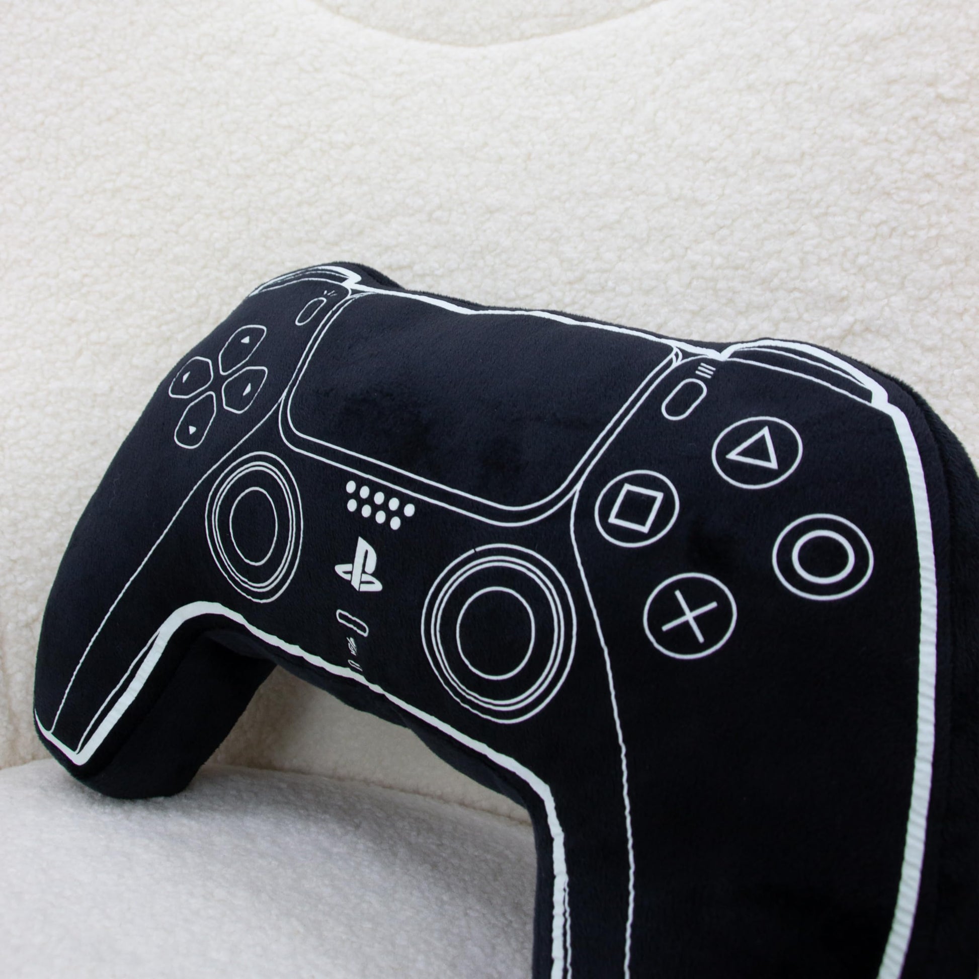 Black PlayStation official licensed controller-shaped cushion pillow, glow-in-the-dark plush decor for bedroom or gaming setup.