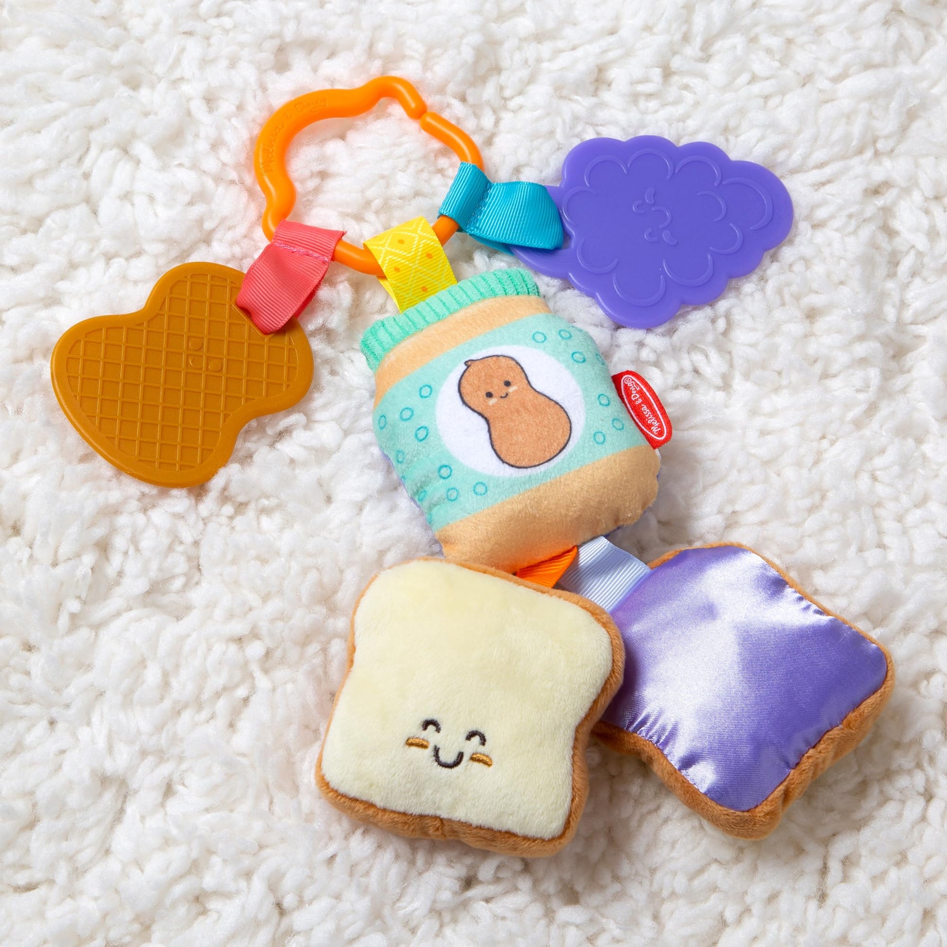Melissa & Doug multi-sensory PB&J take-along clip-on baby toy with colorful textures for infants and toddlers.