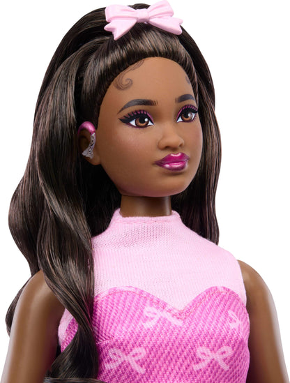 Barbie Deluxe Style Doll #10 in pink denim outfit with bow print, black hair, hearing aids, and handbag accessories.