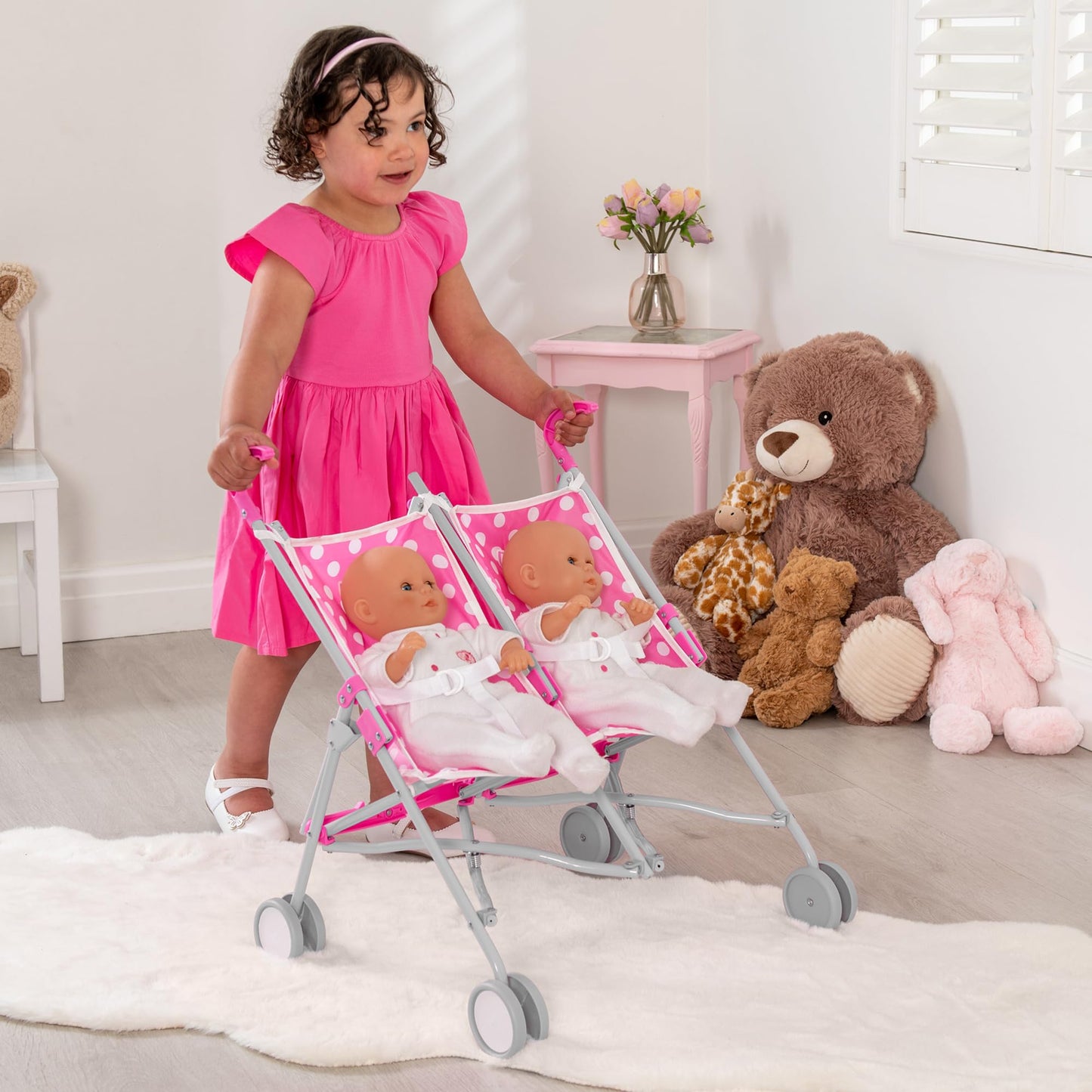 Pink Dolly Tots twin stroller with polka dot design, lightweight double dolls pram for kids, tandem pushchair for role play.