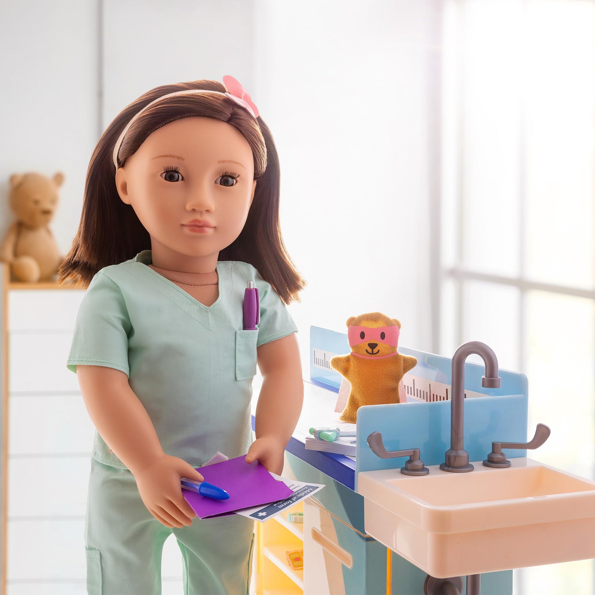 Our Generation doctor scrubs outfit for 18-inch dolls, featuring a surgical top and pants, ideal for pretend play.